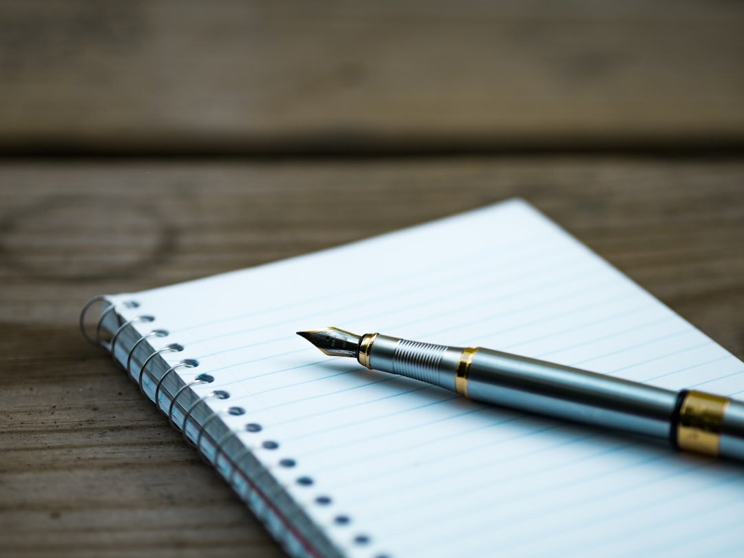 Notebook with a handwritten checklist and pen for will preparation